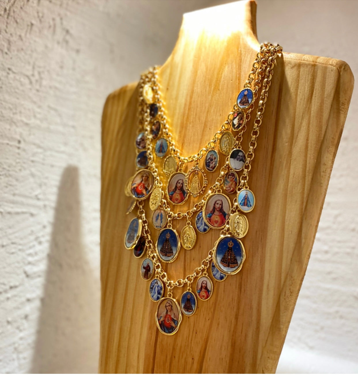 Multi strands necklace with virgins and saints figure charms